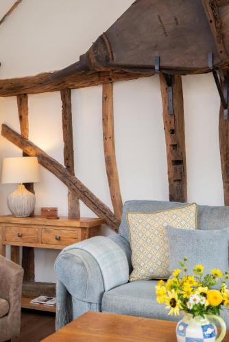 a living room with a couch and a table at Marlborough House Forge in Saxtead