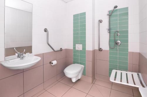 a bathroom with a toilet and a sink and a shower at SUN1 O.R.TAMBO in Johannesburg