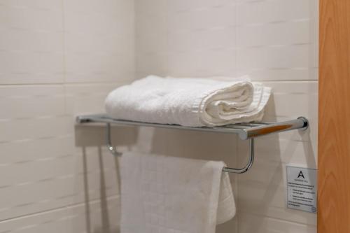 a towel rack with towels on it in a bathroom at Ashorne Hill Leamington Spa in Leamington Spa
