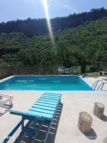 a blue bench next to a swimming pool at Hostel 555 by VL in Alaverdi