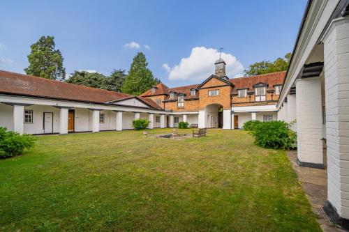 a row of buildings with a grass yard at Ashorne Hill Leamington Spa in Leamington Spa