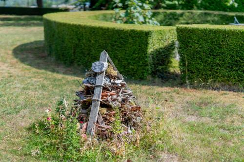 a pile of rocks in the grass in a garden at Ashorne Hill Leamington Spa in Leamington Spa