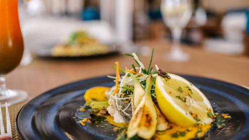 a plate of food on a table next to a glass at Hotel Prestige Agadir Boutique & SPA in Agadir