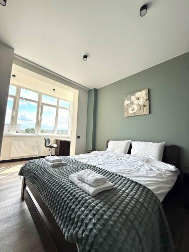 a bedroom with a bed with towels on it at Апартаменти ВІП вул Під Голоском 15 б 9-2 in Lviv