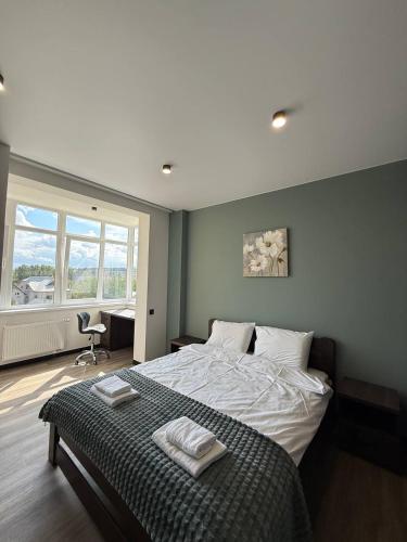 a bedroom with a bed with two towels on it at Апартаменти ВІП вул Під Голоском 15 б 9-2 in Lviv