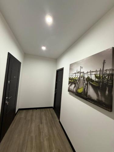a room with two paintings on the wall and two doors at Апартаменти ВІП вул Під Голоском 15 б 9-2 in Lviv