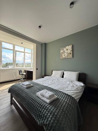 a bedroom with a bed with two towels on it at Апартаменти ВІП вул Під Голоском 15 б 9-2 in Lviv