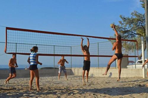a group of people playing volleyball on the beach at Villa Lav in Prigradica