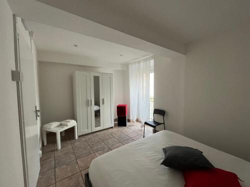 a bedroom with a large white bed and a window at Alloggio FELICE in Labico