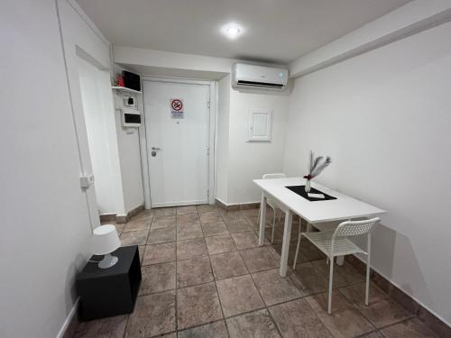 a small room with a white table and chairs at Alloggio FELICE in Labico