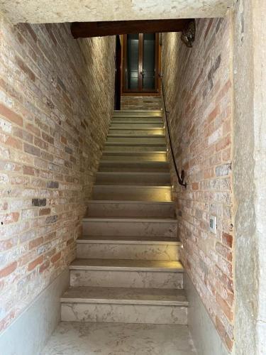 a staircase leading up to a brick wall at Ospizio delle Donzelle in Venice