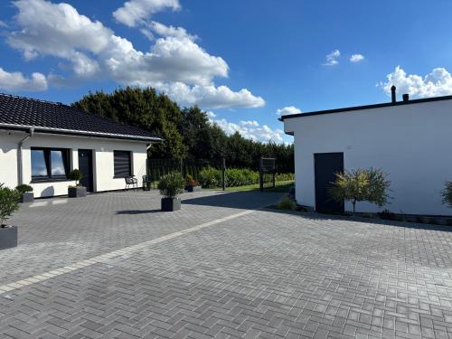 a brick driveway in front of a white building at A7 Apartment 1 in Dätgen