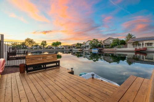 a wooden dock with a boat in a body of water at Modern 3BR Oasis Pool Views Fire Pit & BBQ in Glendale