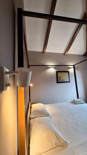 a bedroom with a bed and a lamp in it at Villa Piediprato in Spinetoli
