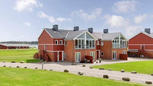 a large red house with a lawn in front of it at G261-Lemvig-Vinkelhagevej-161 in Lemvig