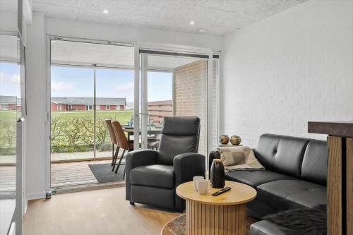a living room with a couch and a table at G261-Lemvig-Vinkelhagevej-161 in Lemvig
