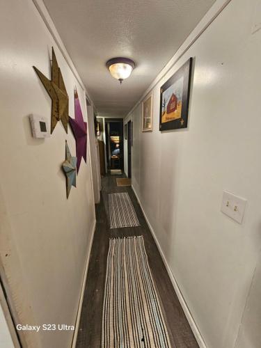 a hallway with rugs on the walls of a house at Over the hill and through the woods in Ironton