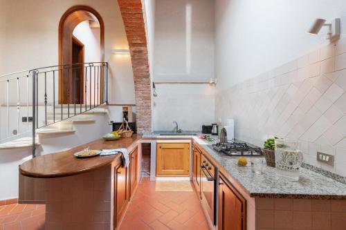 a kitchen with a sink and a counter top at NORMA, Charming Apartments La Spinetta Nel Borgo in Terricciola