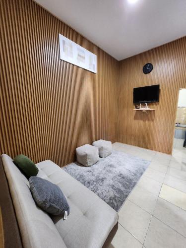 a living room with a couch and a television at Anugrah Syariah Homestay Ciperna in Cirebon
