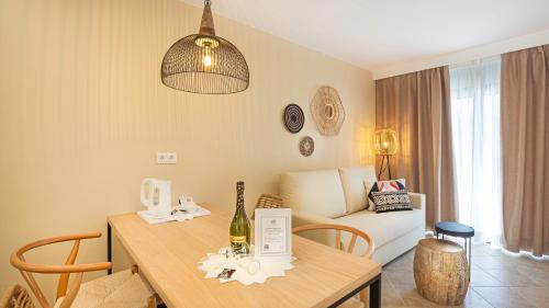 a living room with a table and a couch at Hotel Arena Castillo - New Opening sum 25! in Caleta De Fuste
