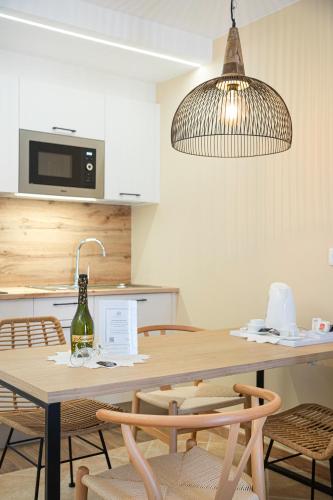 a kitchen with a table with a wine bottle on it at Hotel Arena Castillo - New Opening sum 25! in Caleta De Fuste