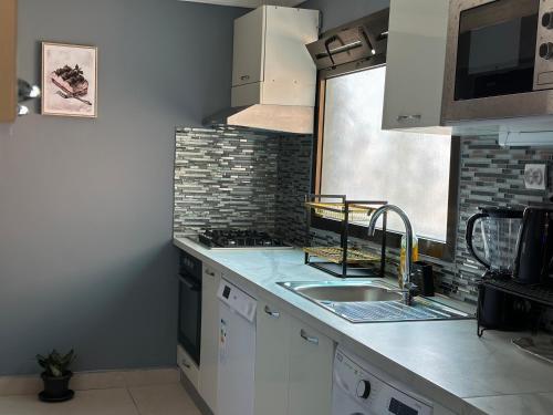 a kitchen with a sink and a counter top at Duende in Pointe-Noire