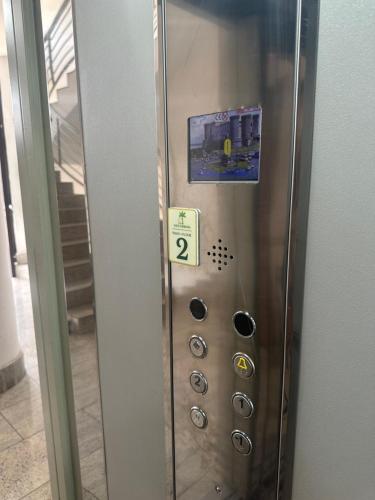 a metal elevator with the number twenty on it at Oasi Urbana in Casoria