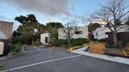 a parking lot with a building and a parking lot at Jeju Dodu Tropical Premium Pool Villa in Jeju