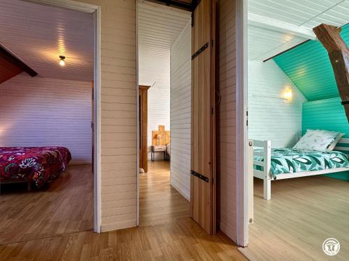 a room with a bed and a room with a door at La Renardière in Chènesaint