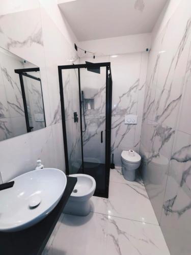 a bathroom with a sink and a toilet at Hotel Mondial in Milan
