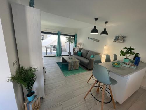 a living room with a table and a couch at MarVillaFuerte - Appart Air-Conditioned Swimming Pool & Private Jacuzzi in Villaverde