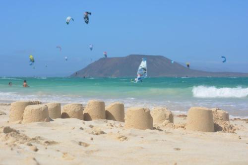 a sand castle on a beach near the ocean at MarVillaFuerte - Appart Air-Conditioned Swimming Pool & Private Jacuzzi in Villaverde