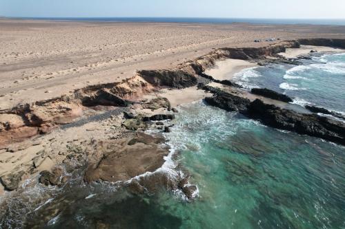 an aerial view of a beach with rocks and water at MarVillaFuerte - Appart Air-Conditioned Swimming Pool & Private Jacuzzi in Villaverde