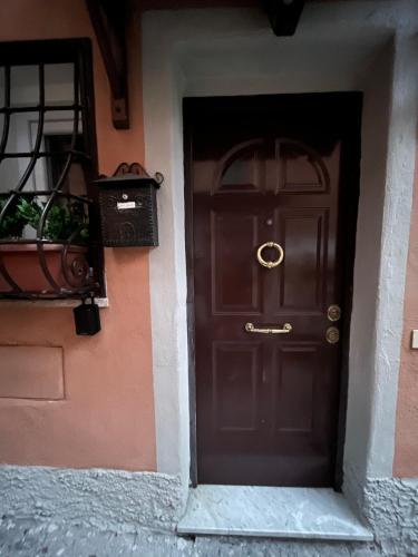 a brown door in a building with a balcony at La Casetta di Andrea e Alessandra in Rocca di Papa
