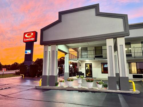 a gas station with potted plants in front of it at Econo Lodge in Lenoir City