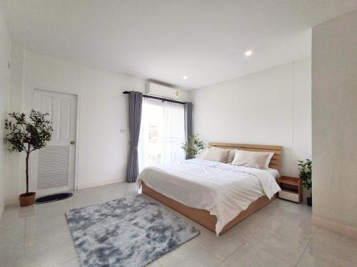 a bedroom with a large bed and a window at Dalbit Thai Stay 2 Bedroom Patong house - 8mins walk to Jungcyelon Bangla Rd in Patong Beach