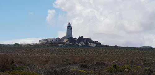 a lighthouse on an island in a field at The Loft on Malmok in Paternoster