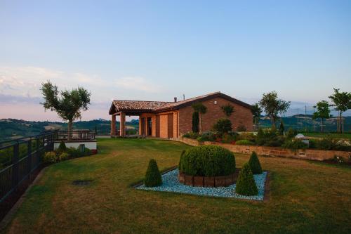 a house with a garden in front of it at Le Orchidee Villa in Roncofreddo