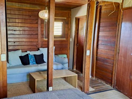 a bedroom with a bed and a wooden wall at Casa Calexico in Kralendijk