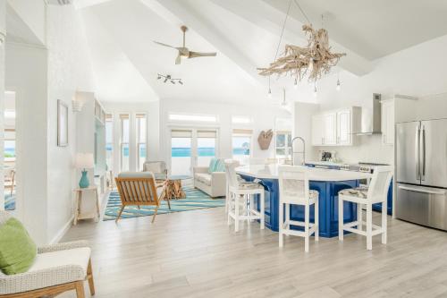 a kitchen and living room with a blue island at The Ambergris Grand in San Pedro