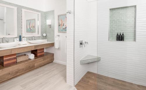a bathroom with two sinks and a shower at The Ambergris Grand in San Pedro