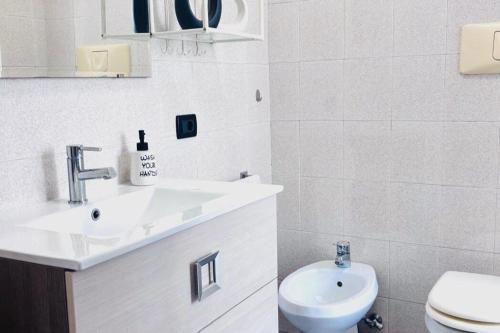 a white bathroom with a sink and a toilet at Borghetto in Vicenza