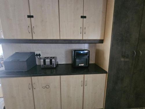 a kitchen with a microwave and a toaster on a counter at Family Home with Entertainment Area in Westville