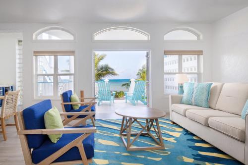 a living room with a couch and chairs and a table at The Ambergris Grand in San Pedro