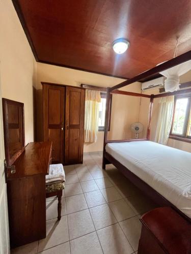 a bedroom with a large bed and a wooden ceiling at Ocean Walk Guesthouse in Trankill