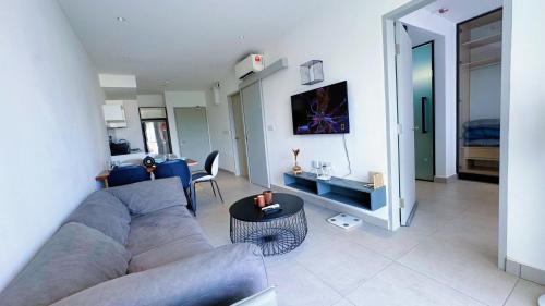 a living room with a couch and a table at DK Impian Damansara Townview Fully Air-Con SUITE in Shah Alam