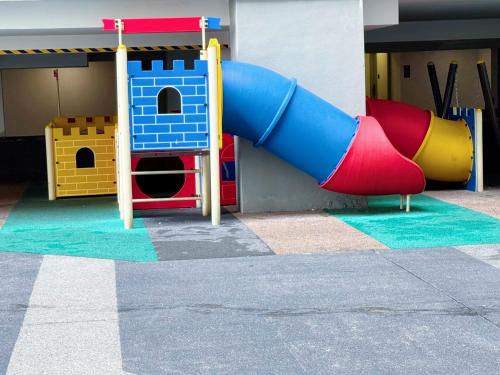 a playground with a slide in a building at DK Impian Damansara Townview Fully Air-Con SUITE in Shah Alam