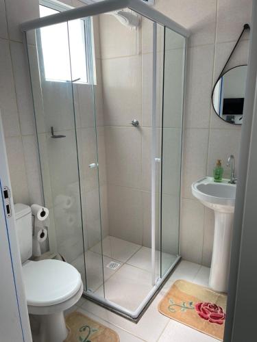 a bathroom with a shower with a toilet and a sink at Apartamento Pelotas in Pelotas