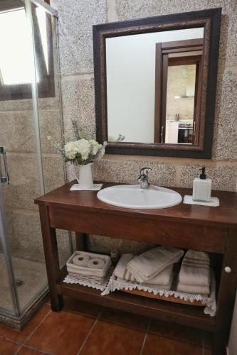 a bathroom with a sink and a mirror at Vilaboa Paradise in Villanueva
