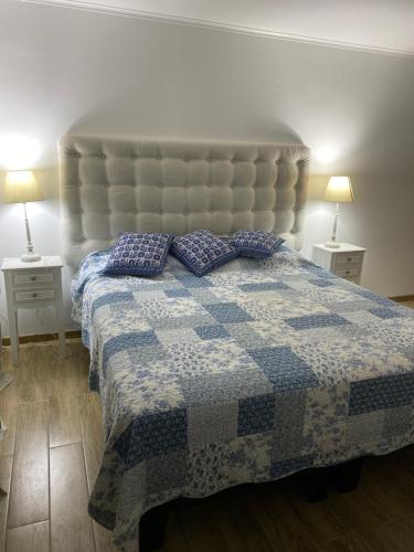 a bedroom with a bed with two pillows on it at Casa con piscina in Bahia Inglesa